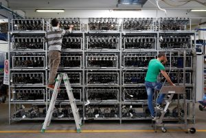 Employees work on bitcoin mining computers at a factory in Florence. Alessandro Bianchi / Reuters